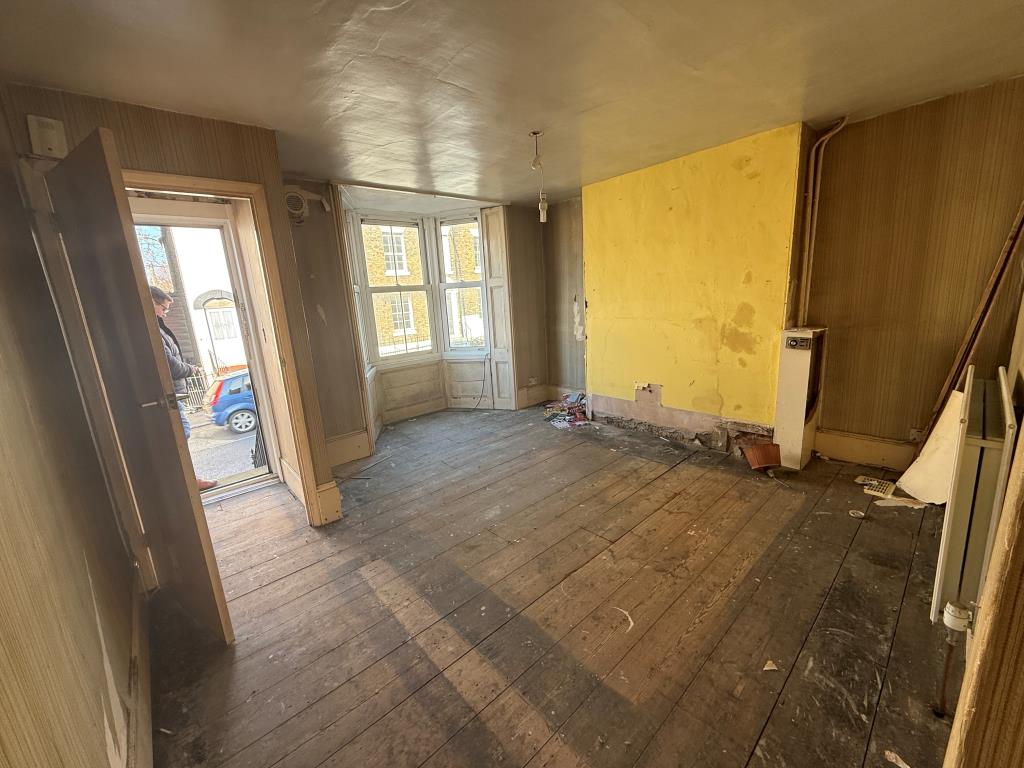 Lot: 50 - MID-TERRACE HOUSE FOR REFURBISHMENT - Living room with bay window